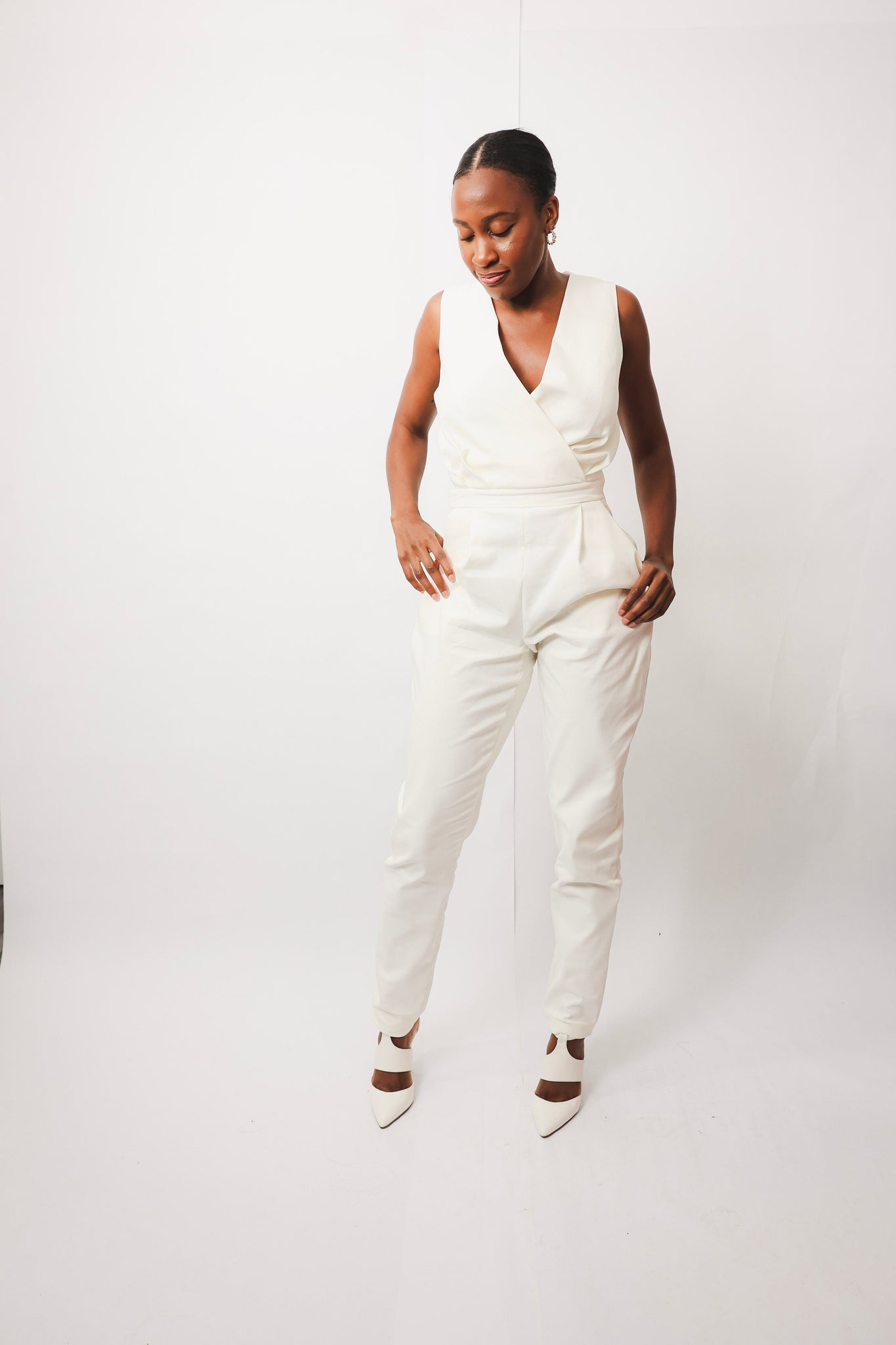 Yemi Sleeveless Jumpsuit with V-neck design, worn by model in size 10.