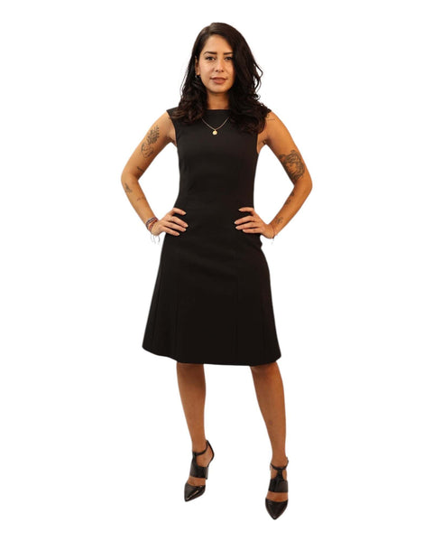 Ena Black Midi Dress with sleeveless design and swing skirt.